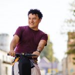 a man rides an electric scooter