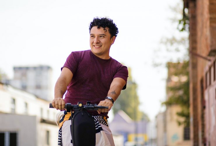 a man rides an electric scooter