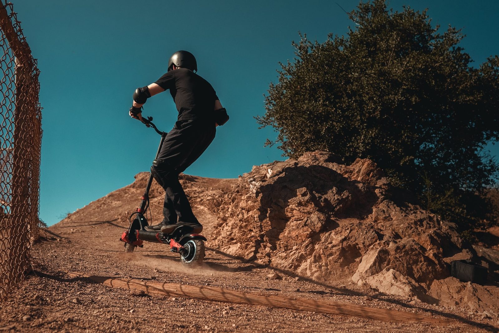 a man rides uphill on an off-road electric scooter