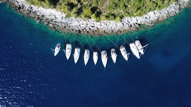 a-group-of-boats-floating-on-top-of-a-body-of-water