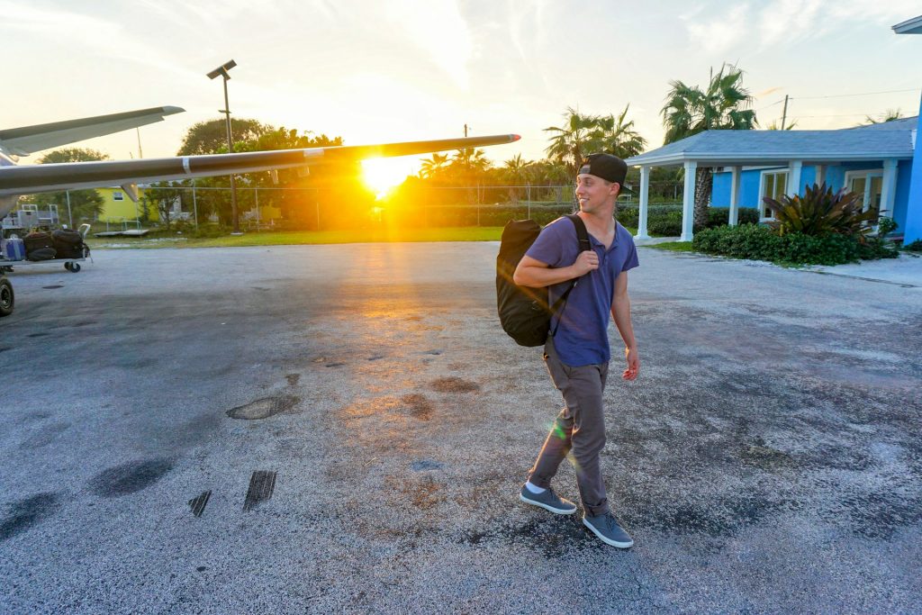 smiling-man-walking-while-looking-side-view