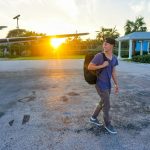smiling-man-walking-while-looking-side-view